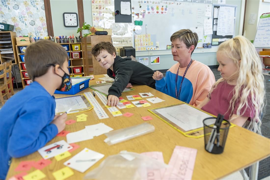 Students working on project in class with teacher